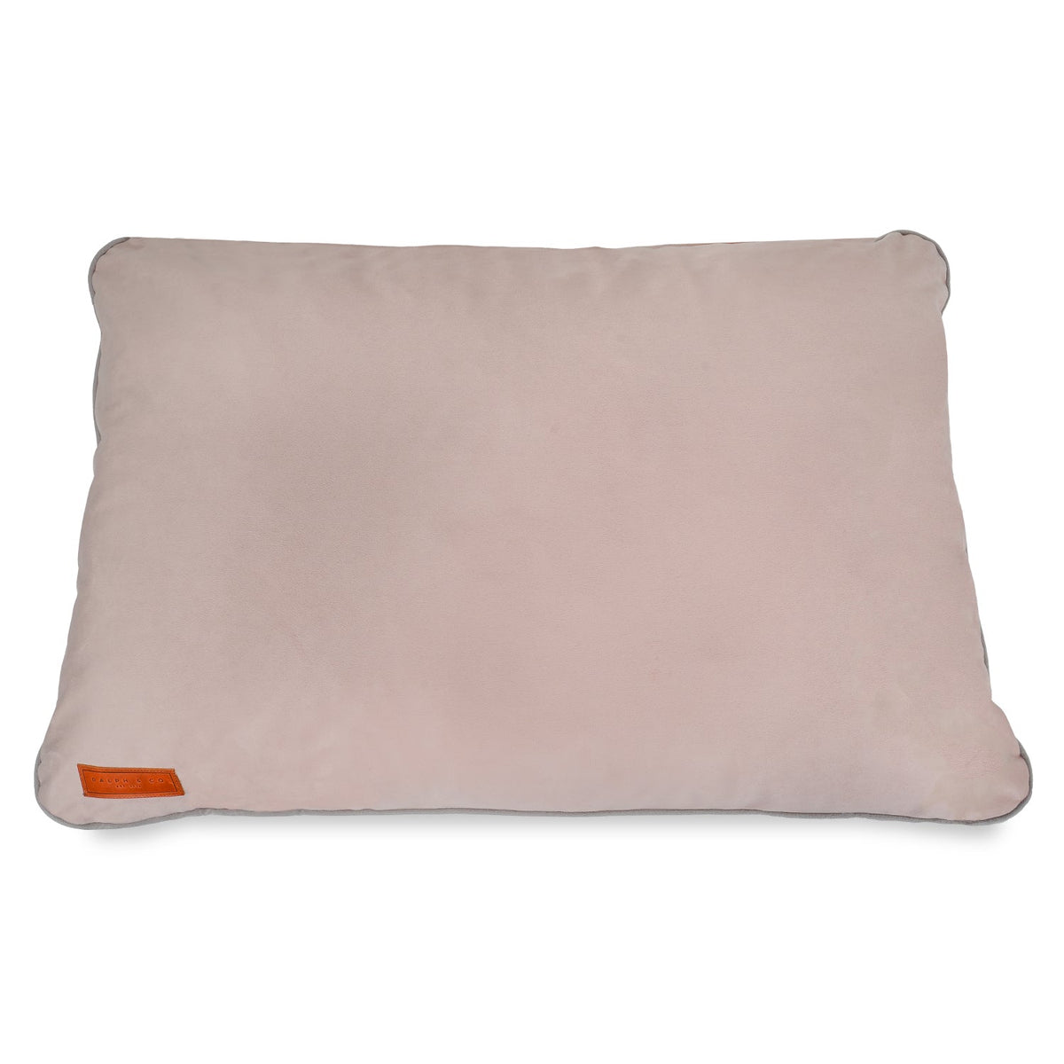 Pink dog pillow with a small orange tag on a white background