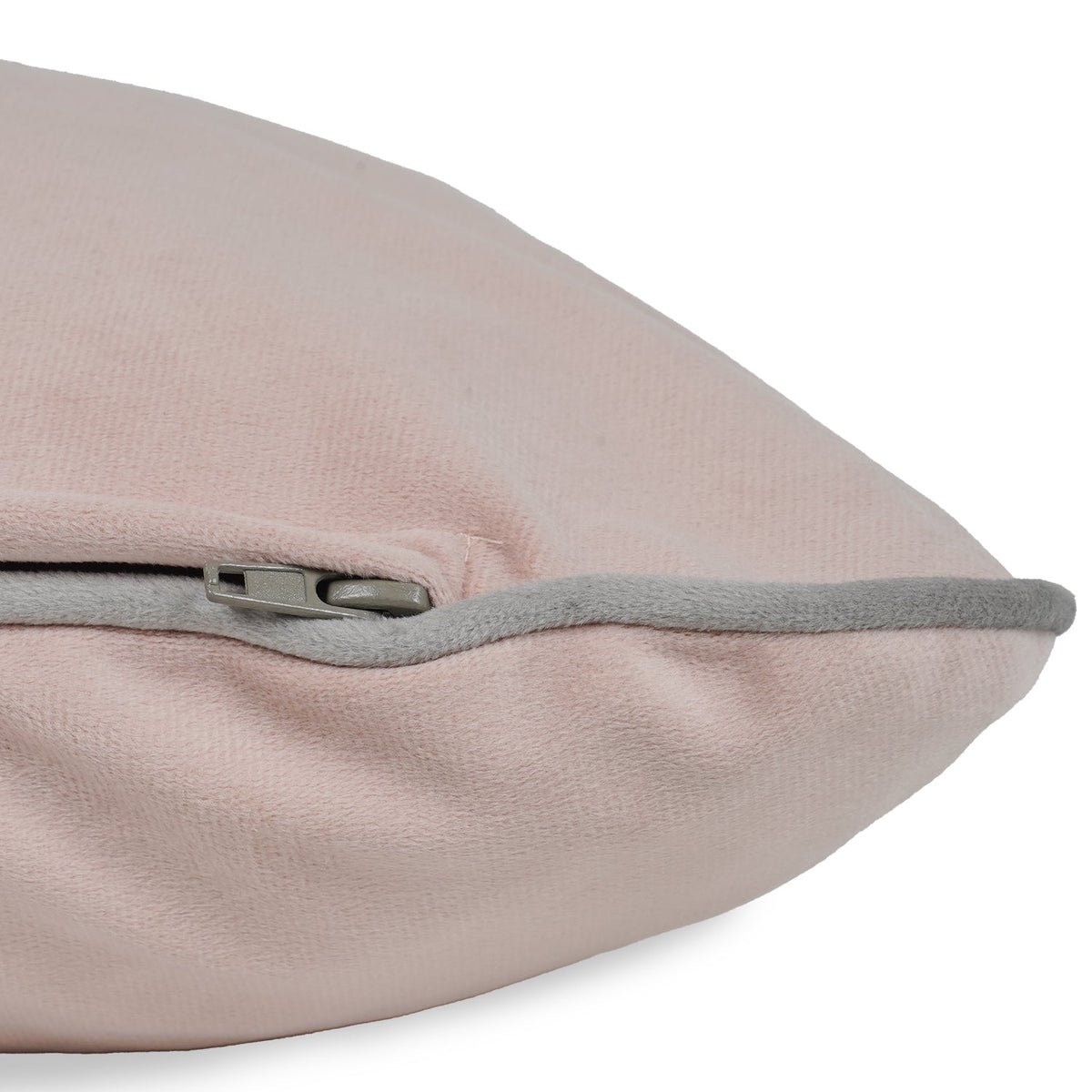 Close-up of a pink pillow with a zipper on a white background