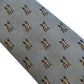 A close-up of a gray necktie with a repeating pattern of small brown French Bulldog illustrations, set against a plain white background.