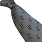 A light blue-gray silk necktie with a repeating pattern of small brown and gold bulldog motifs, shown on a plain white background.