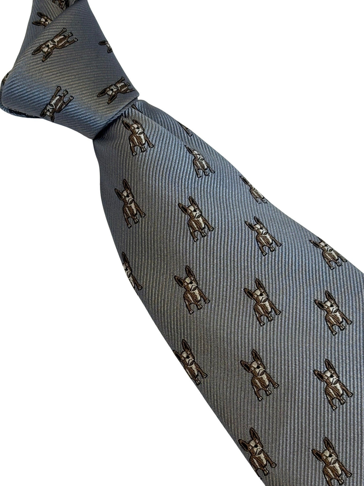 A light blue-gray silk necktie with a repeating pattern of small brown and gold bulldog motifs, shown on a plain white background.