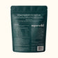 The back of a dark teal Superwild dog supplement pouch, displaying detailed text about benefits, feeding guide, and ingredients on a light cream background.