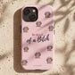 A light pink phone case with a pattern of small poodle illustrations and the text 'Be Kind.