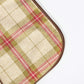 Plaid patterned mat with a brown border on a white background