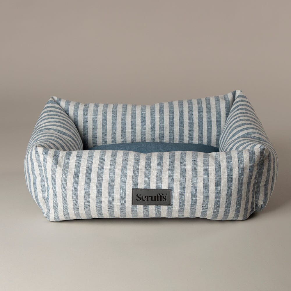 Striped pet bed with a Scruffs label on a beige background