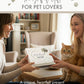 Two women holding a gift box with a cat sitting between them, labeled 'Thoughtful Gift for Pet Lovers'.