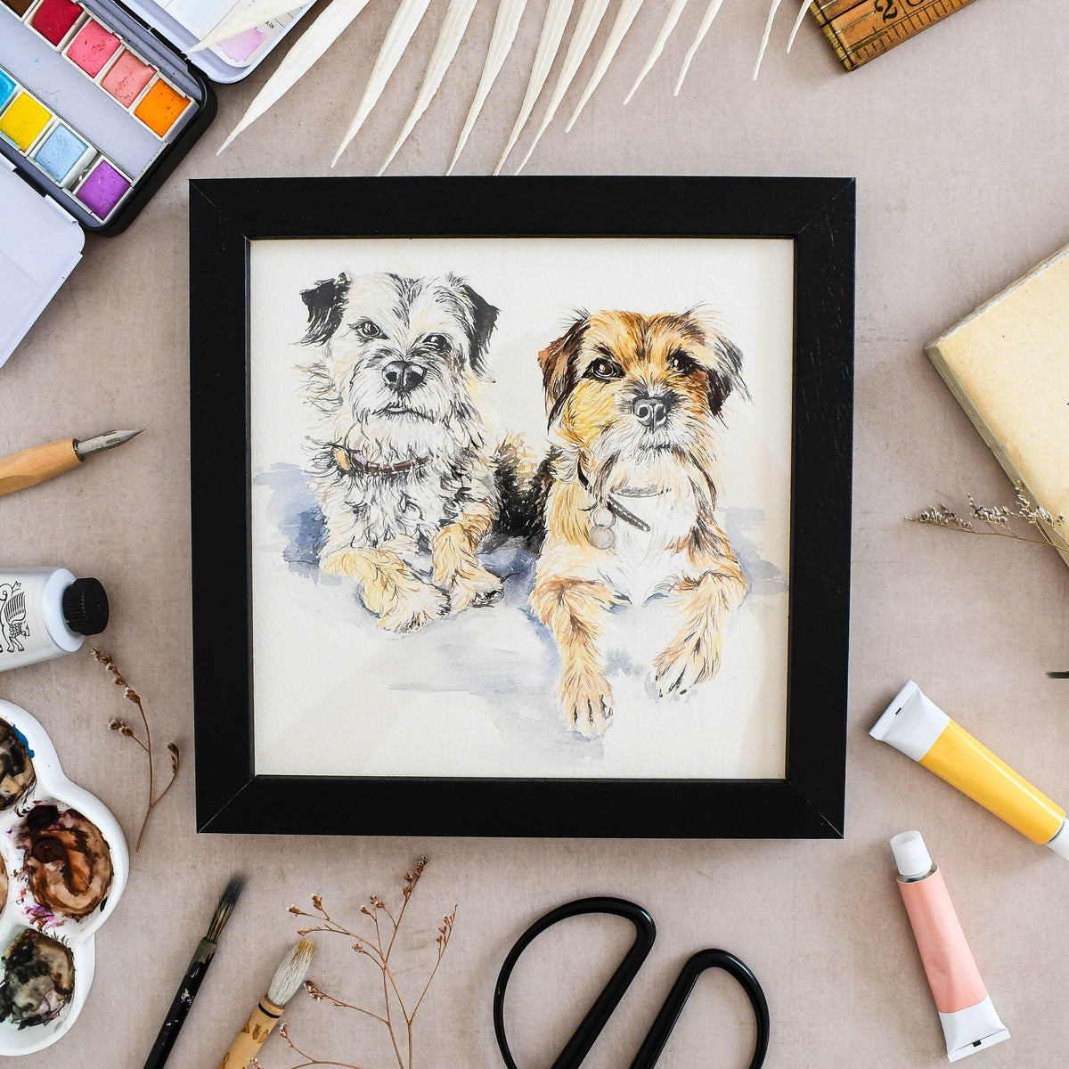 Framed watercolour portrait of two dogs created from photographs