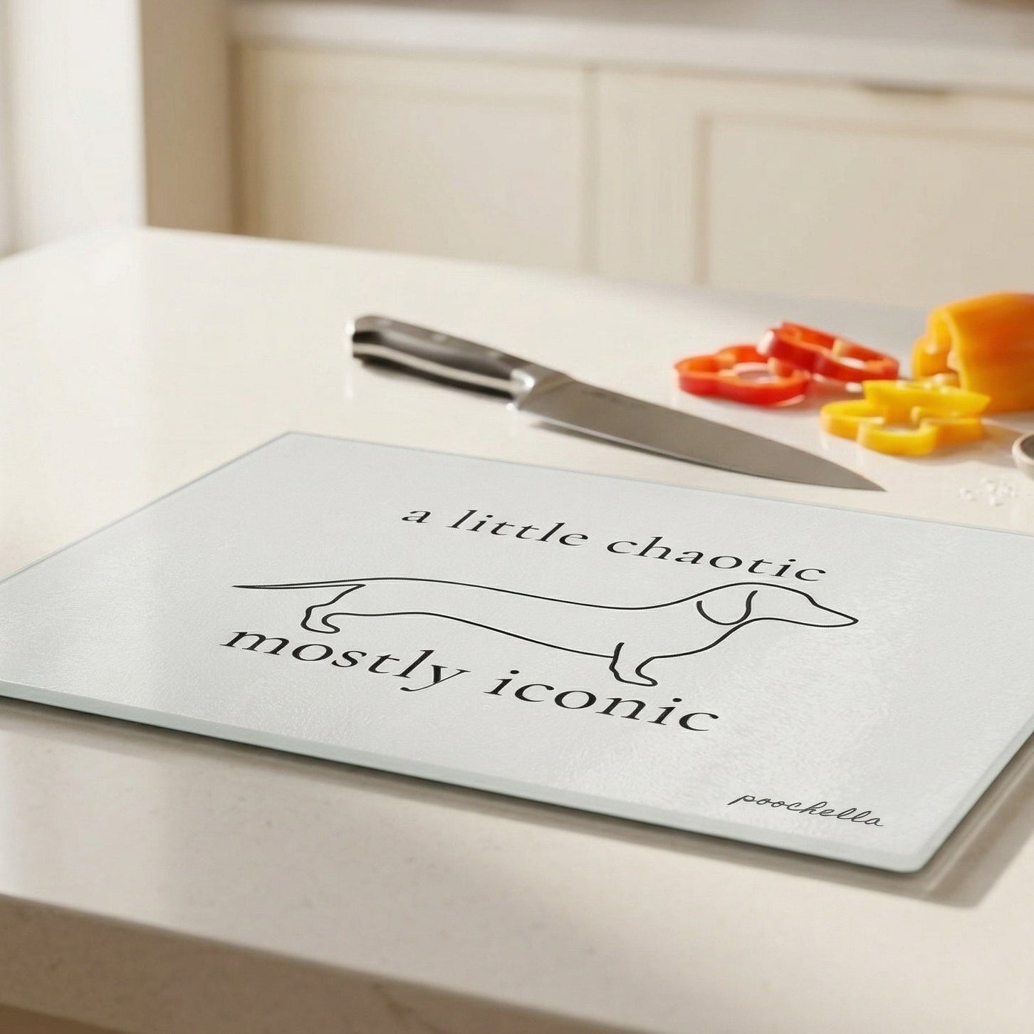 Chopping board with dachshund design and text on a kitchen counter