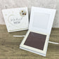Pet memorial paw pad with packaging on a wooden surface