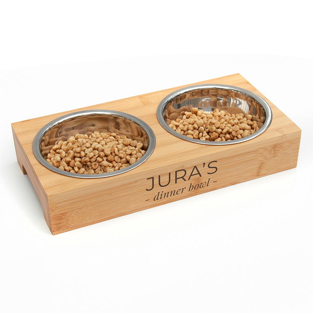 Pet food bowl set with wooden base and 'JURA'S' branding on a white background