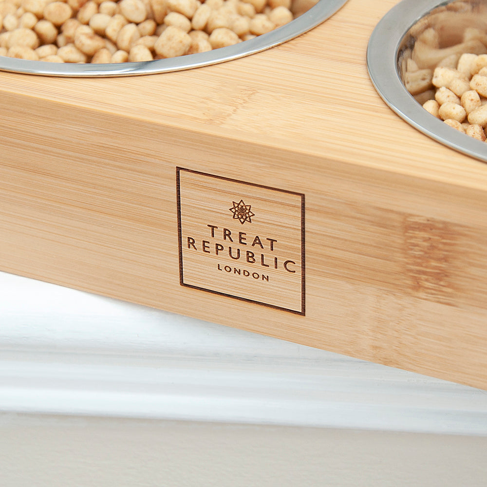 Wooden pet food bowl with 'Treat Republic London' branding on a white background