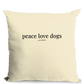 Beige pillow with 'peace love dogs' text on a white background