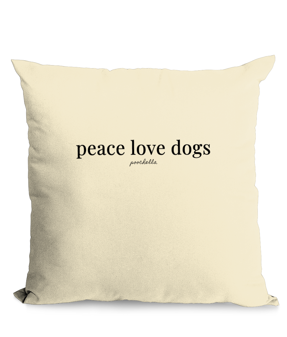 Beige pillow with 'peace love dogs' text on a white background
