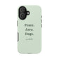 A sage green phone case with the text 'Peace. Love. Dogs