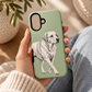 Loyal Labrador sage green phone case held in hand to show scale and design