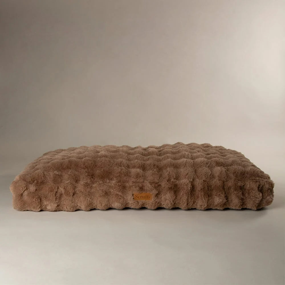 Brown textured pet bed mattress on a beige background
