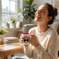 woman laughing with poochella dog mug in her hand