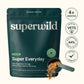 A dark teal stand-up pouch of superwild Super Everyday dog supplement powder, shown on a light beige background with circular callout badges reading 3+ Months, Made by Vets, 84% Quality of Life Improved, and Potent Formula. A scoop of the brown powder is shown in front of the pouch.