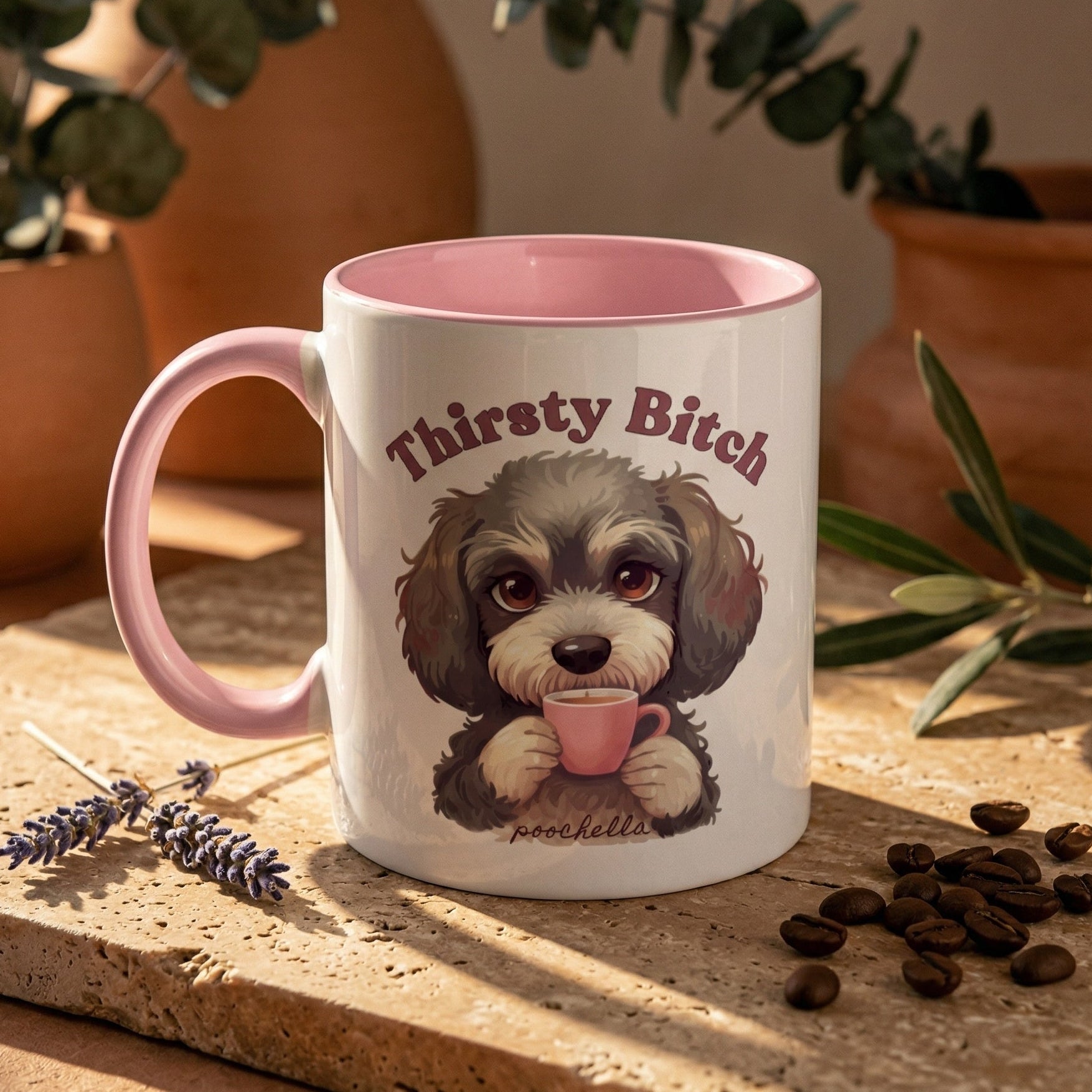 Mug with a dog cockapoo illustration and text 'Thirsty Bitch' on a wooden surface with plants in the background.