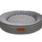 Gray pet bed with a brown label on a white background