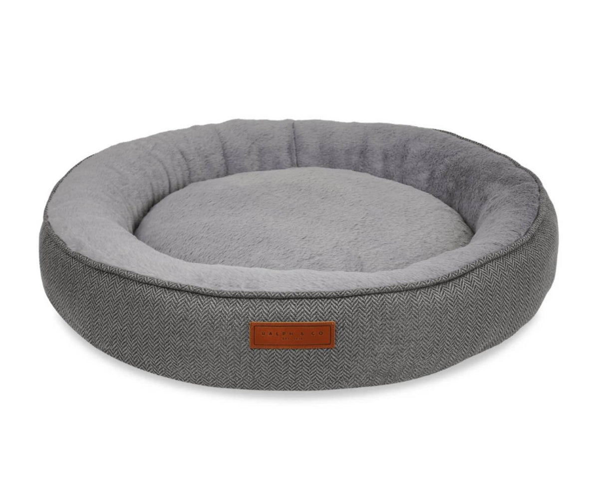 Gray pet bed with a brown label on a white background