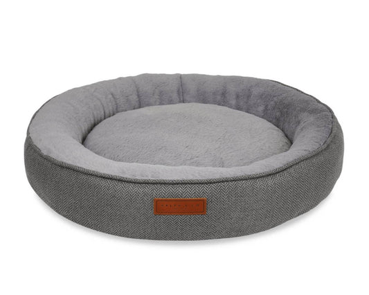 Gray pet bed with a brown label on a white background