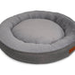 Gray pet bed with a textured exterior and plush interior on a white background
