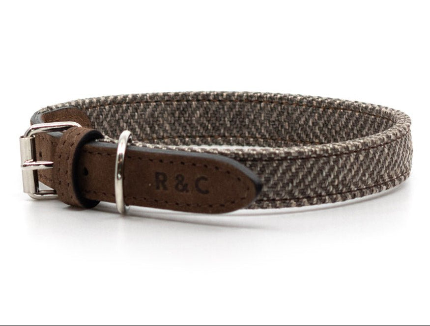Brown woven dog collar with leather buckle on a white background