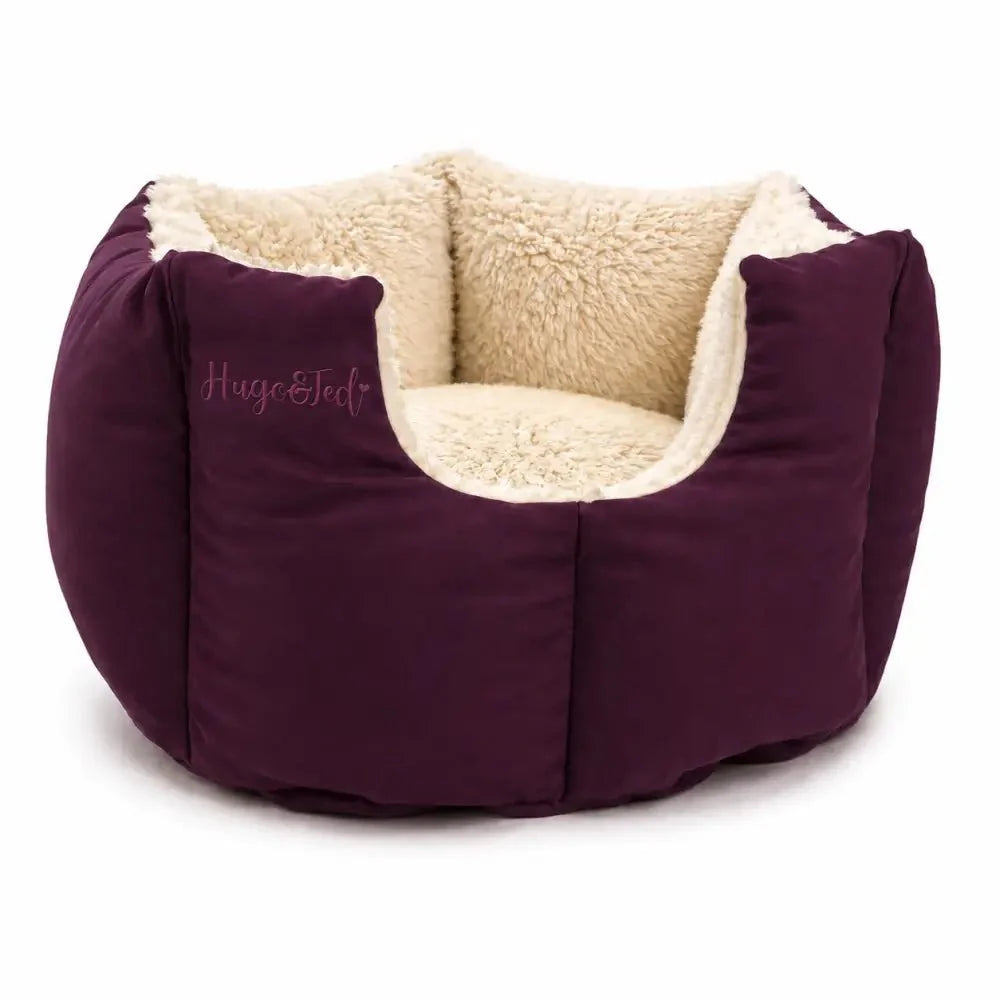 Purple pet bed with beige interior on a white background