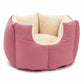 Pink pet bed with beige interior on a white background