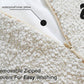 Close-up of a textured dog bed with a zipper and text indicating waterproof inner pillow and removable zipped covers for easy washing.