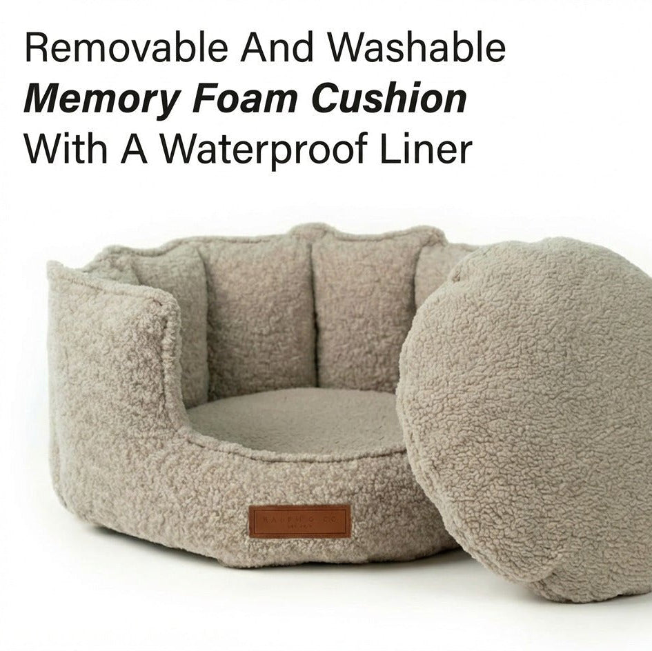 Beige pet bed with round cushion and text about removable and washable memory foam cushion with waterproof liner.