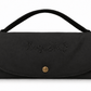 A black fabric handbag with a top handle, featuring the brand name 'Hugo & Ted' embroidered on the front flap and a gold snap button closure, set against a plain white background.
