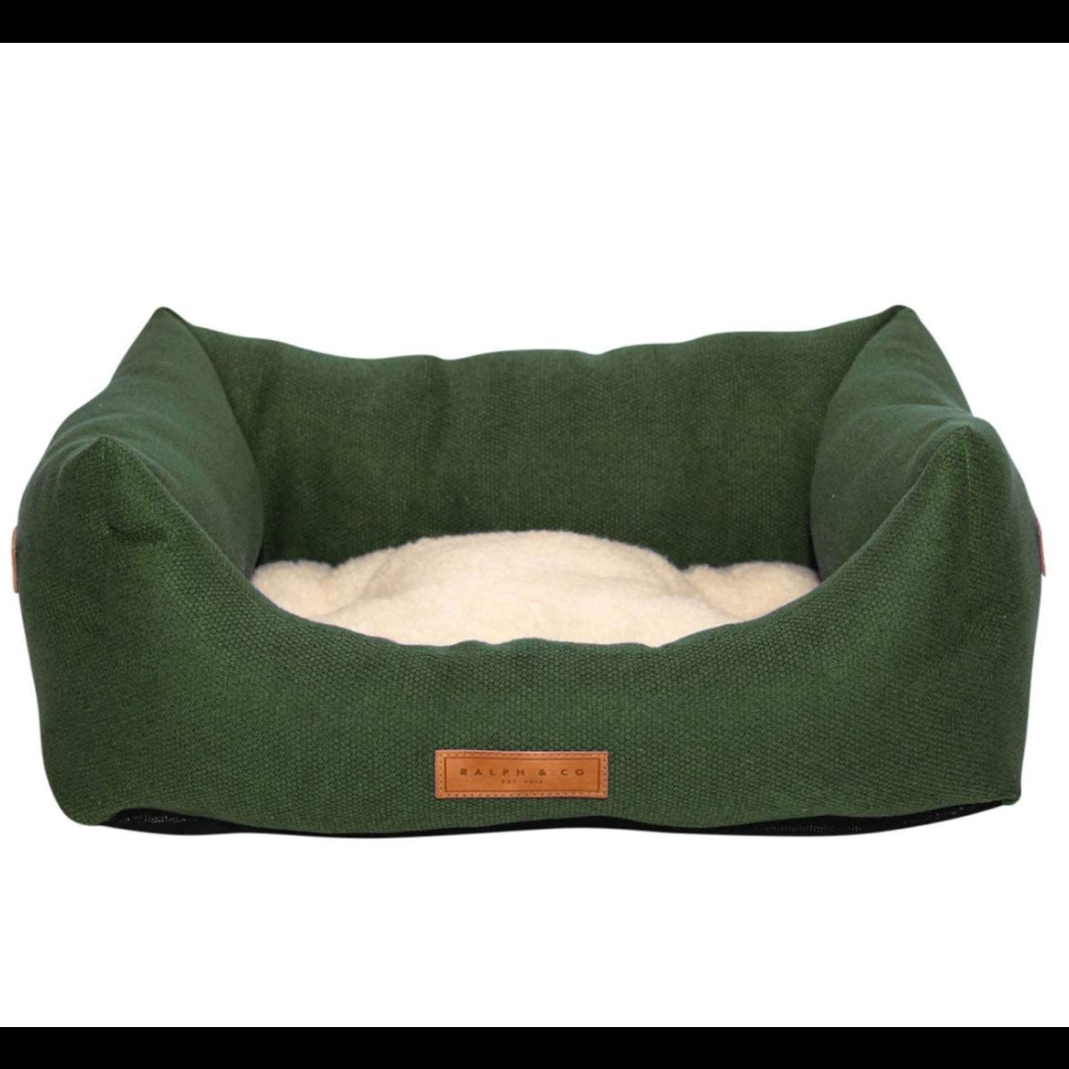 Green pet bed with a fluffy cushion on a white background