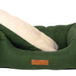 Green pet bed with a white cushion on a white background