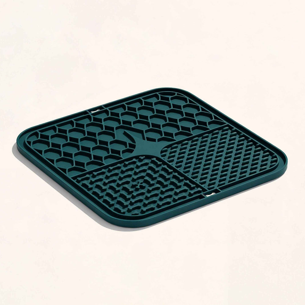 Green rubber mat with textured surface on a white background