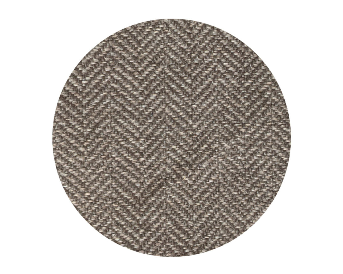 Round fabric swatch with a herringbone pattern on a white background