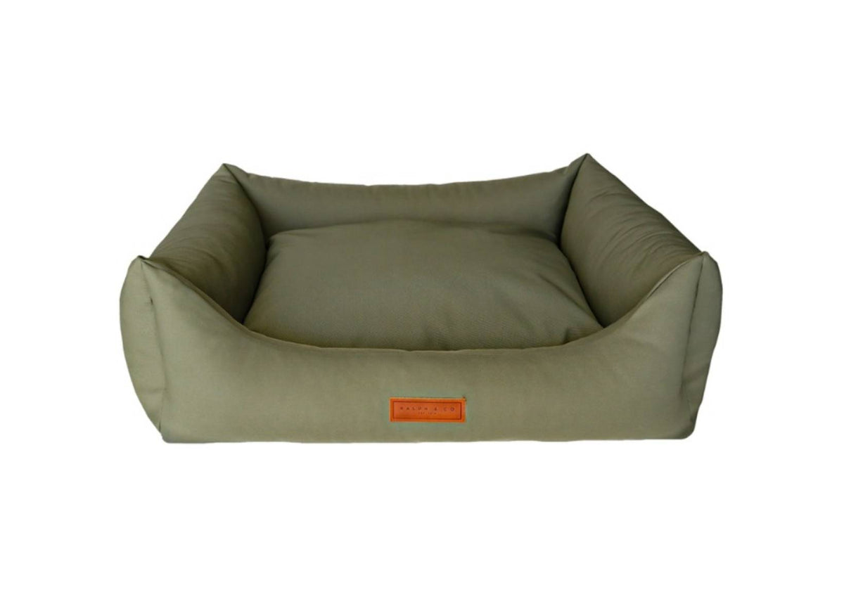 Green pet bed with a visible brand logo on a white background