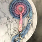 A multicolored rope dog lead with a silver metal clip, hand-dyed and spliced in shades of pink, blue, and white, with a sweet dreams pattern.